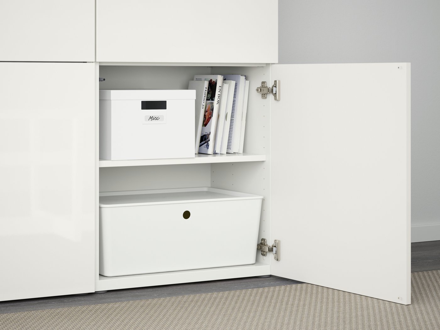 A white/Selsviken high-gloss/white BESTÅ storage combination with doors in the living room
