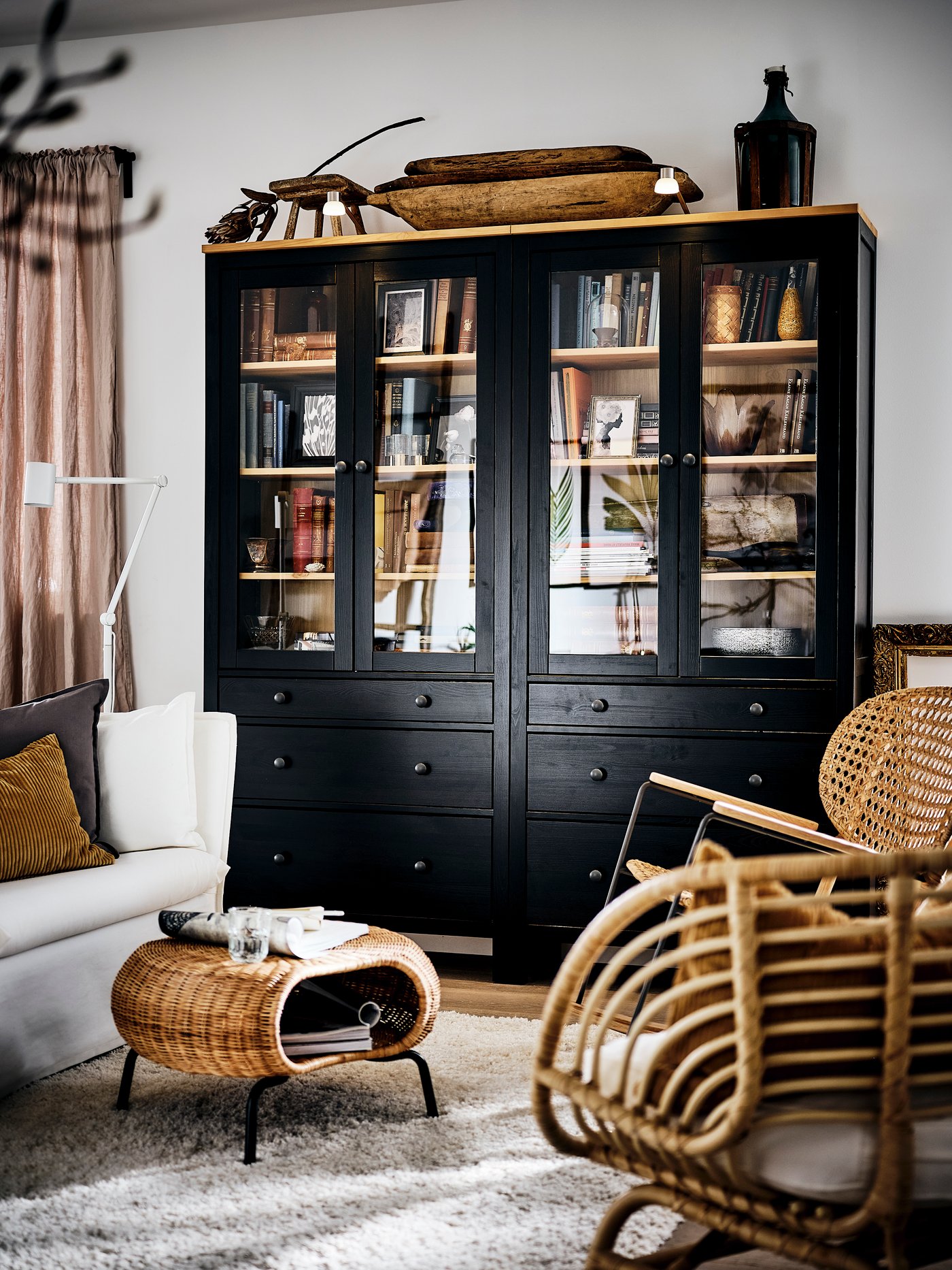A black-brown/light brown HEMNES glass-door cabinet with 3 drawers in the living room