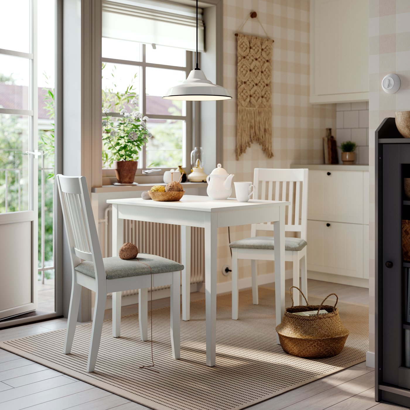 A white NÄSINGE table and beige-grey NÄSINGE chair in a kitchen setting. 