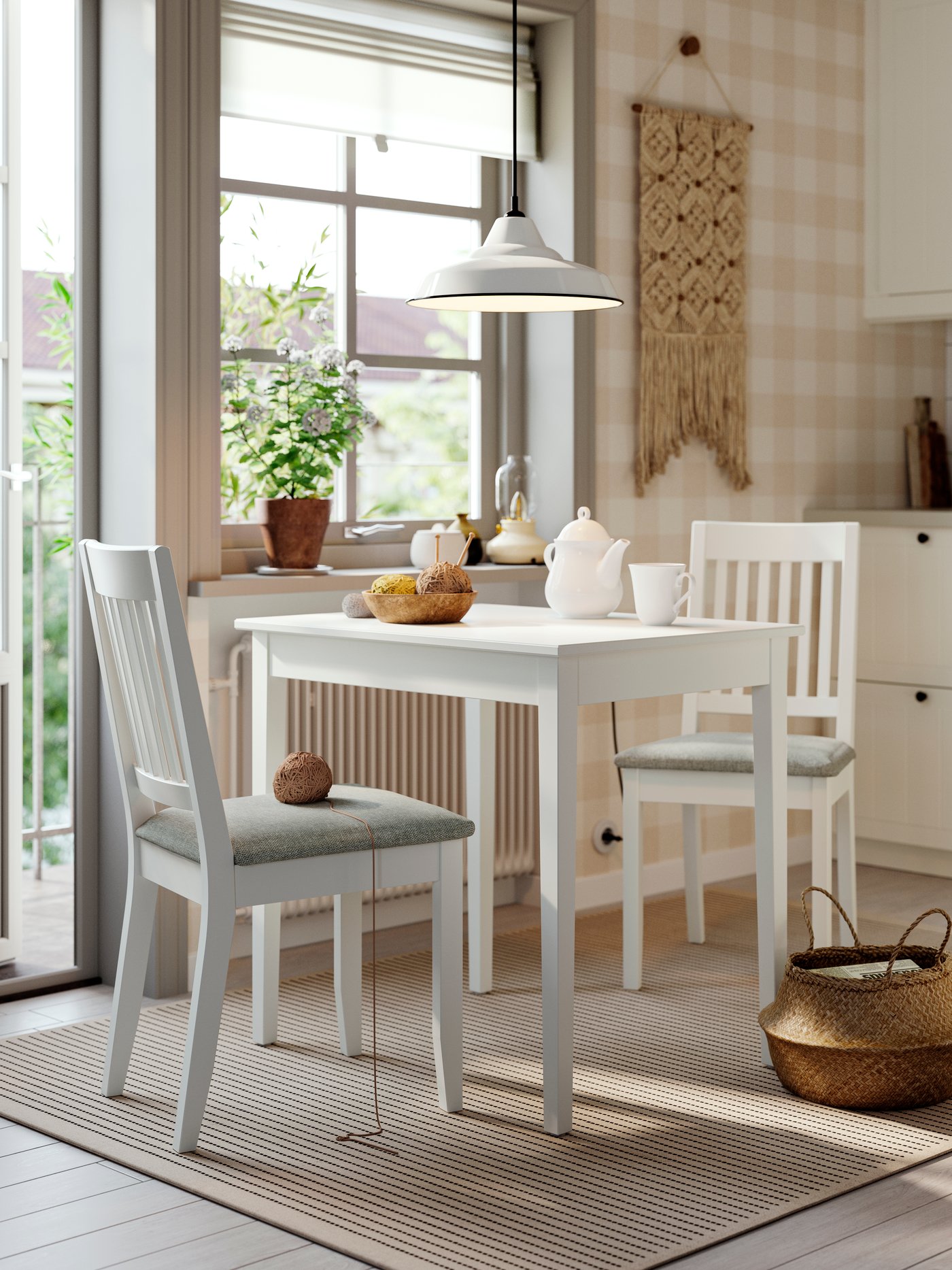 A white/white Tibbleby beige-grey NÄSINGE table and 2 chairs in the dining room
