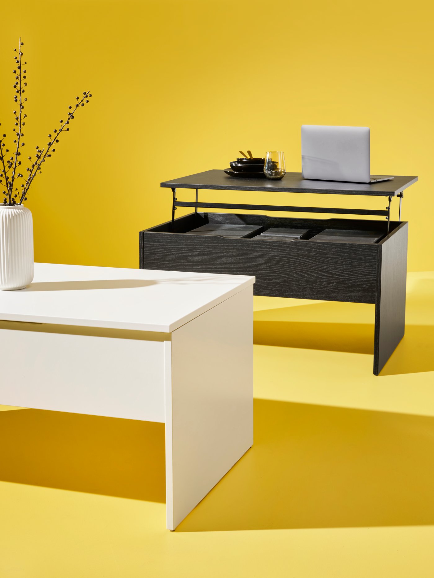 A white ÖSTAVALL adjustable coffee table