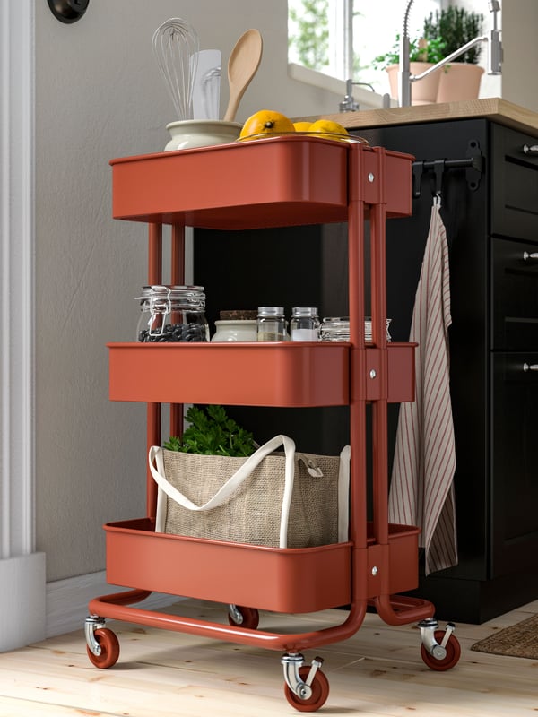 A red-brown RÅSKOG trolley