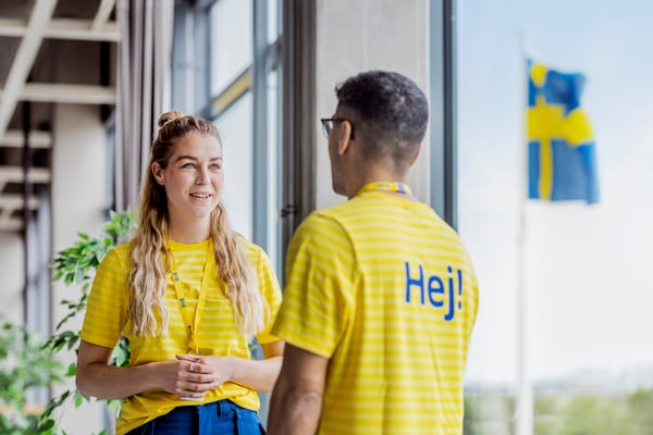 Two IKEA employees talk to each other in the IKEA shop