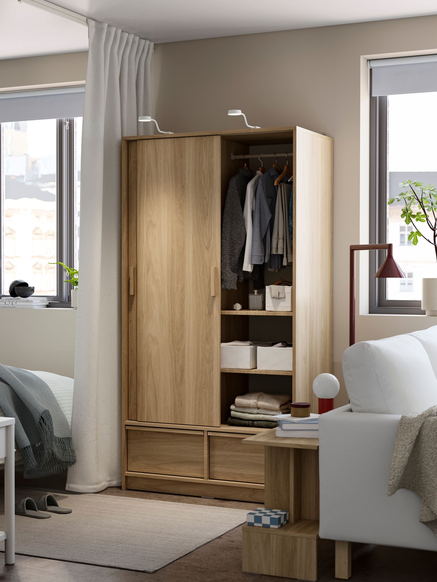 An oak effect ANKARUDDEN wardrobe with sliding doors in the bedroom
