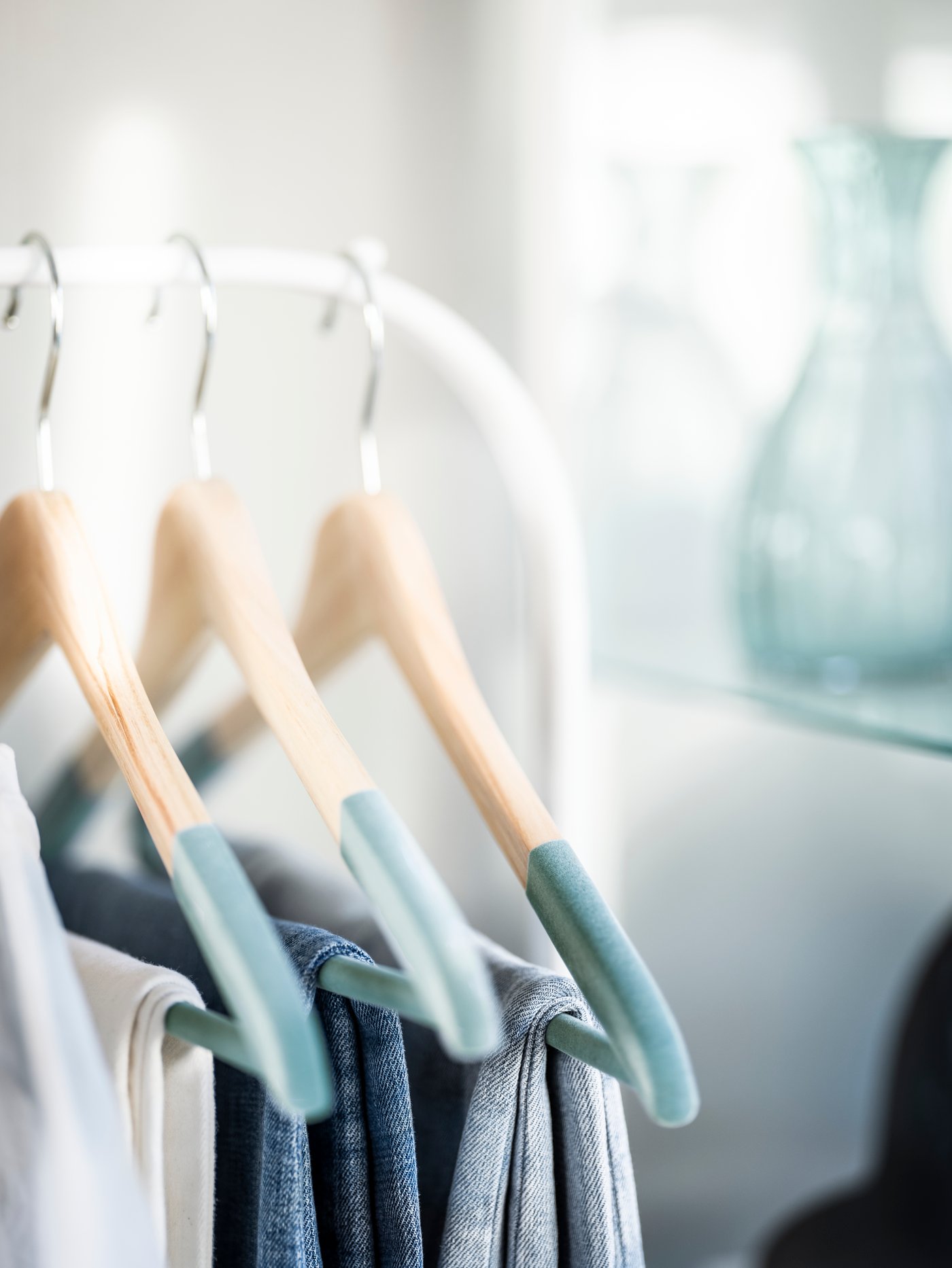 A white MULIG clothes rack in the bedroom