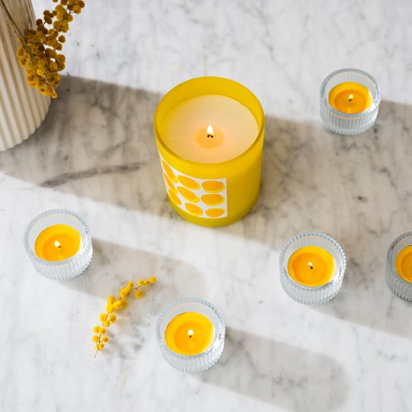 A clear glass FINSMAK tealight holder