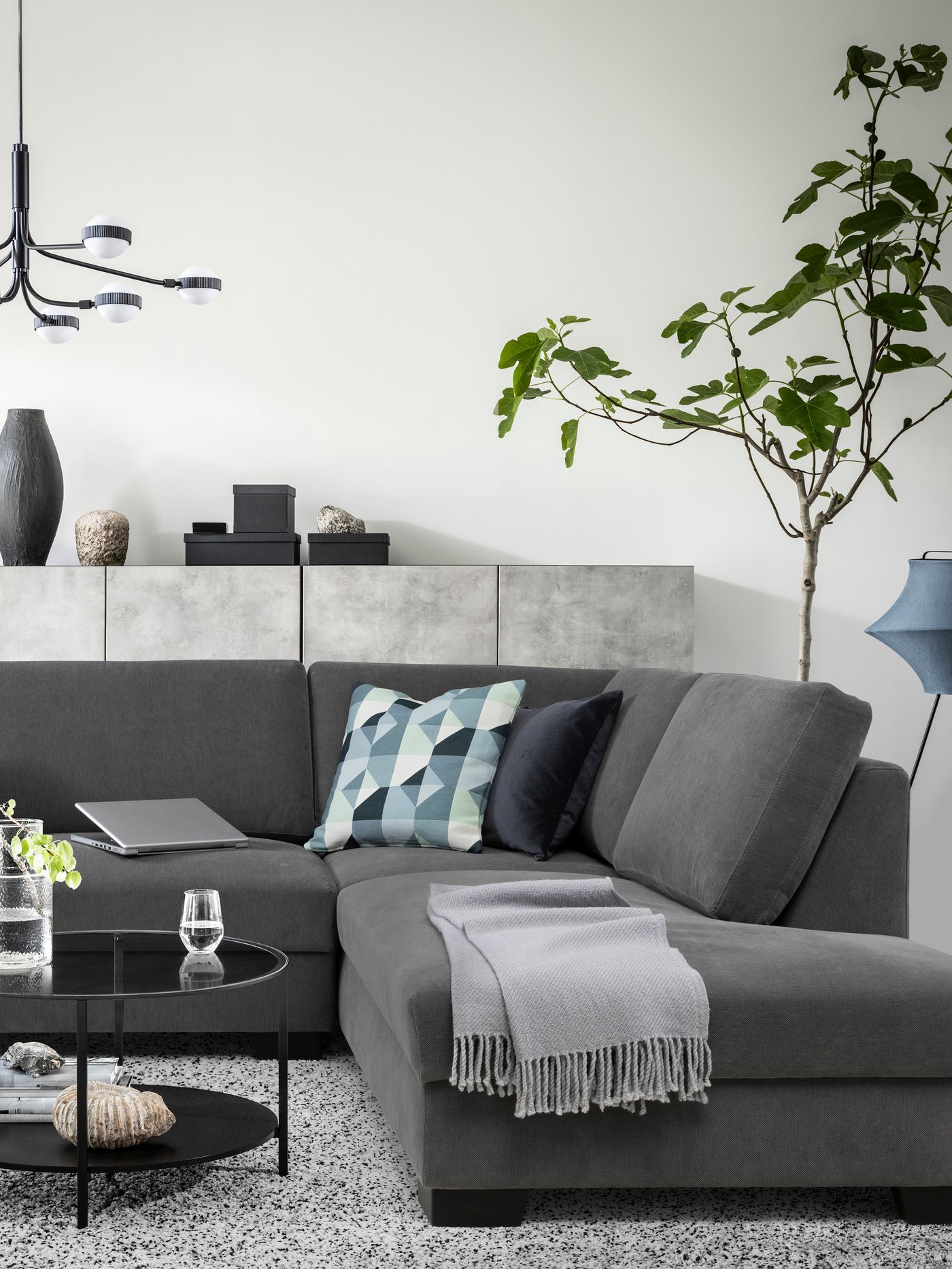 A dark grey SÖRVALLEN five-seater sofa in the living room.