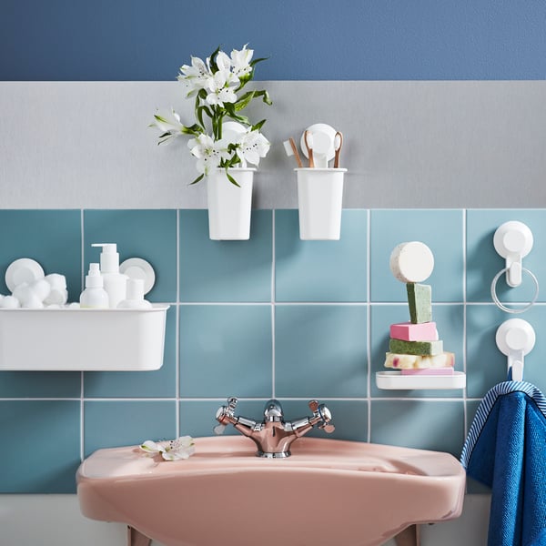 A white TISKEN basket with suction cup in the bathroom