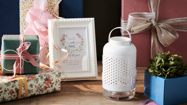 A white ÄDELHET lantern for tealight in the living room