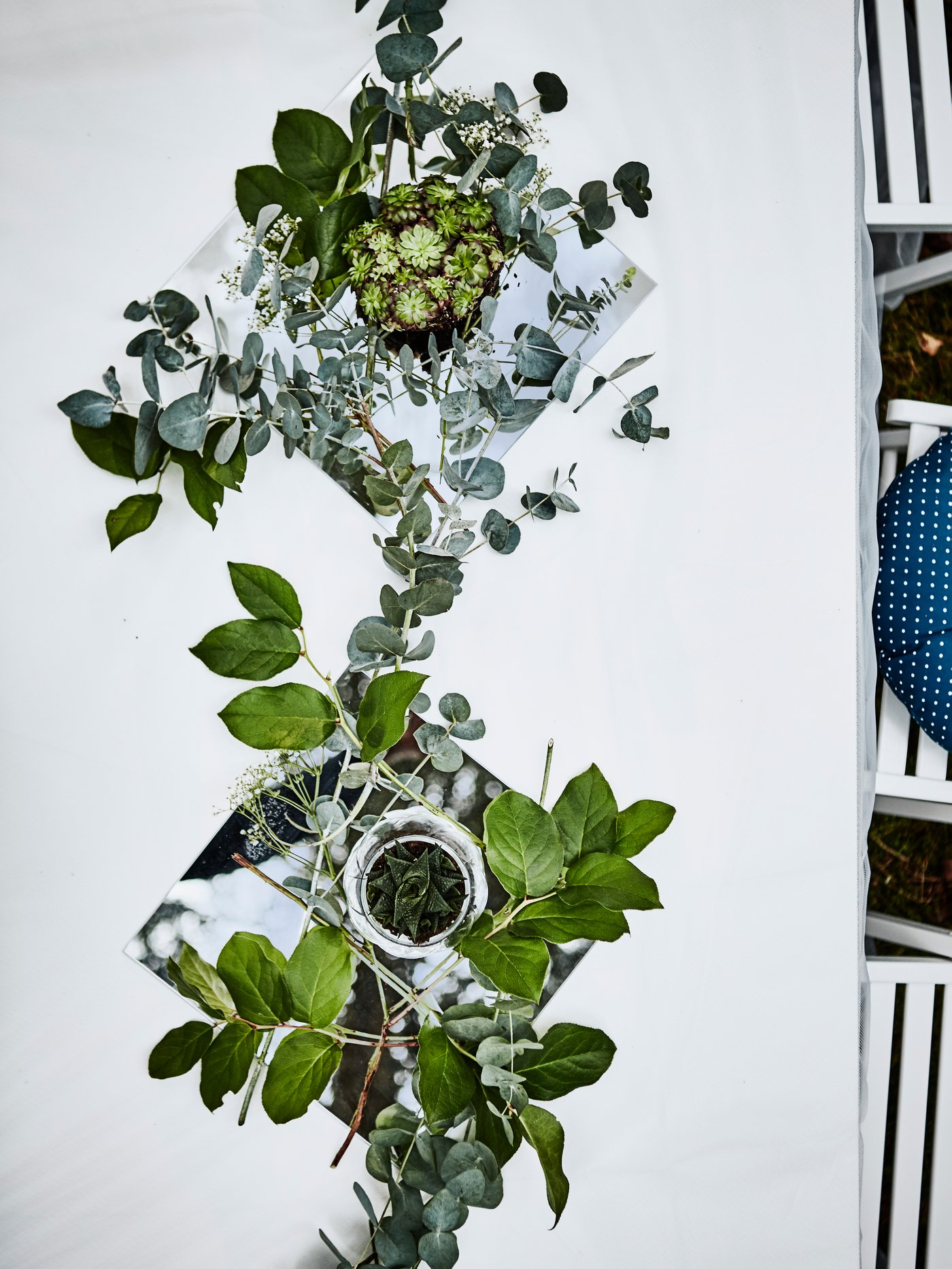 Artifical flowers are used to decorate a table runner. 