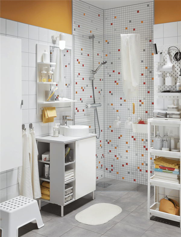 A white VESKEN shelf unit in the bathroom