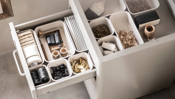 A plastic/beige NOJIG organiser in the home office