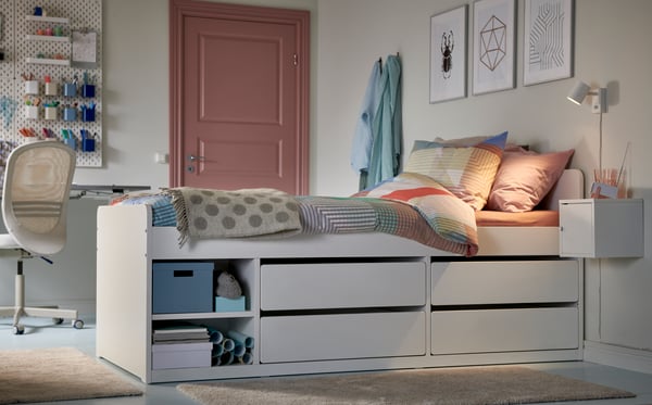 A white SKÅDIS pegboard in the bedroom