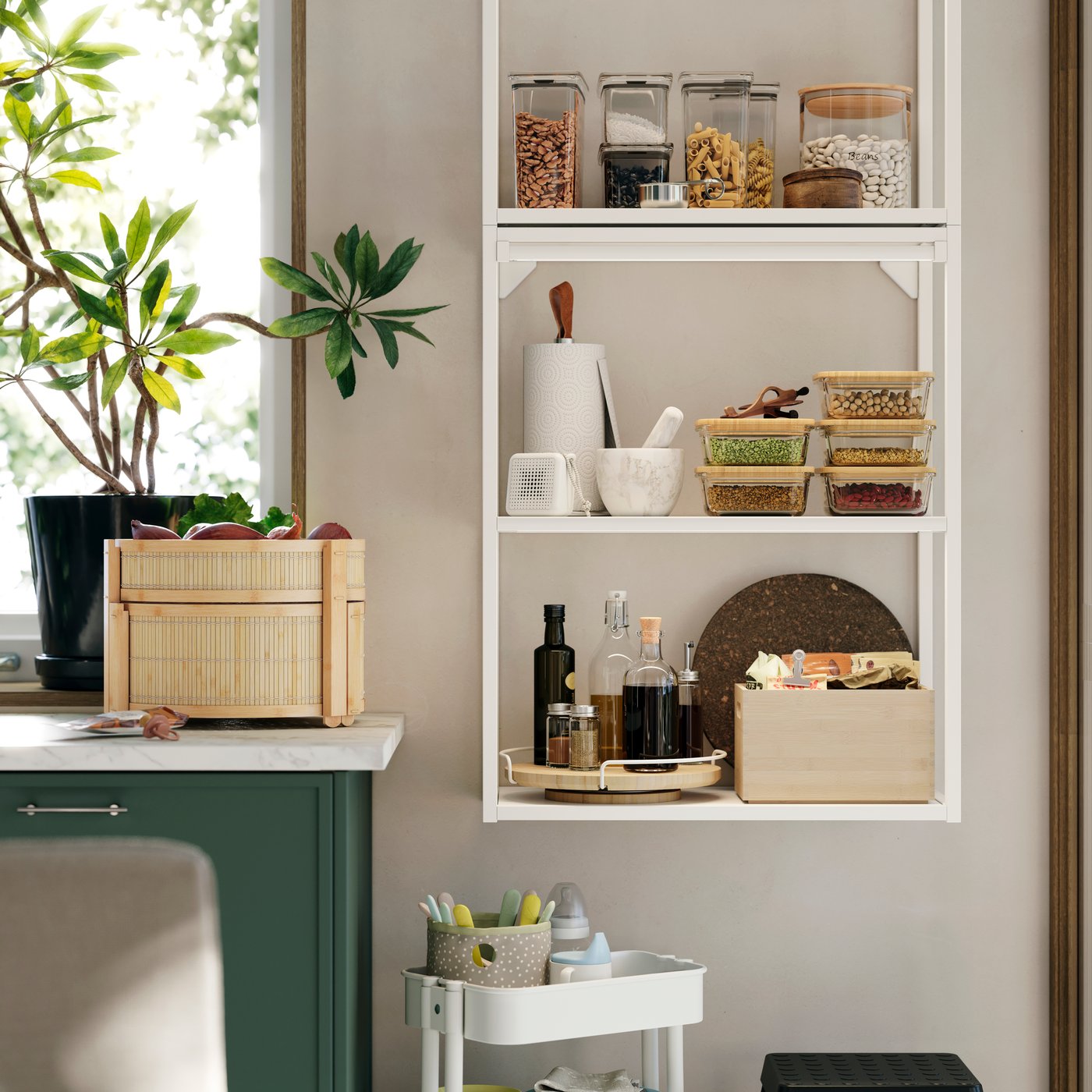 An ENHET wall frame is mounted on a kitchen wall and there’s a basket made of bamboo on the kitchen worktop next to it.