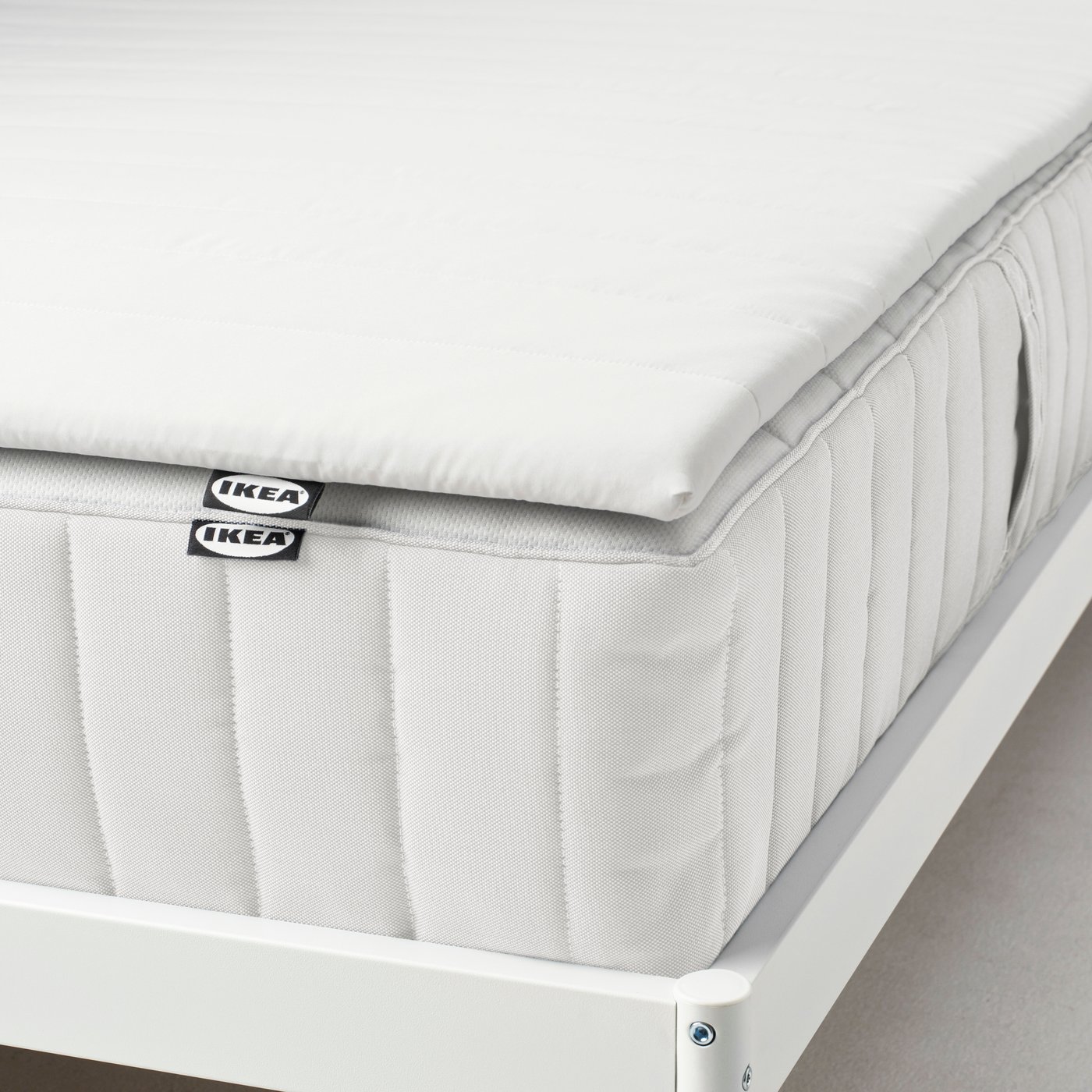 A white NOPAKTE mattress pad