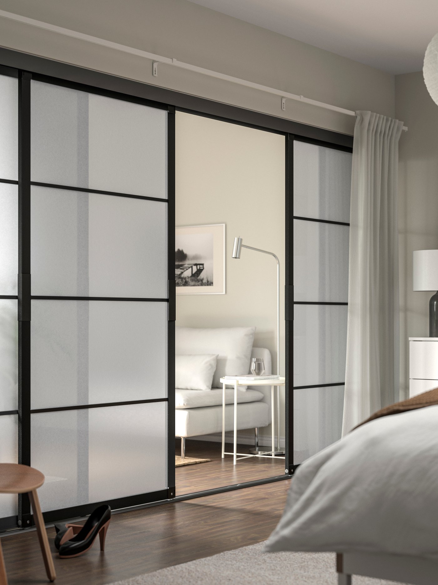 Open SKYTTA sliding doors that seperate the bedroom from the livingroom