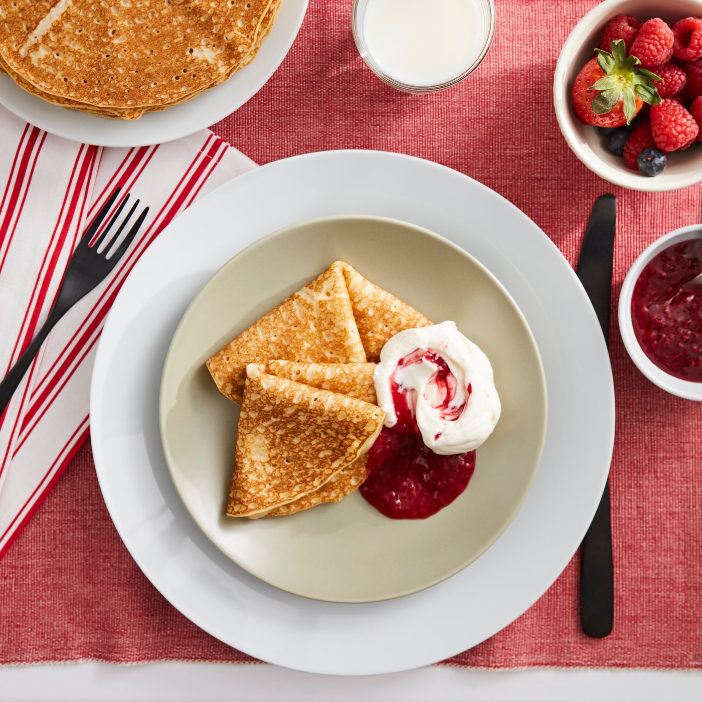 PANNKAKOR pancakes on a plate with jam and cream. 