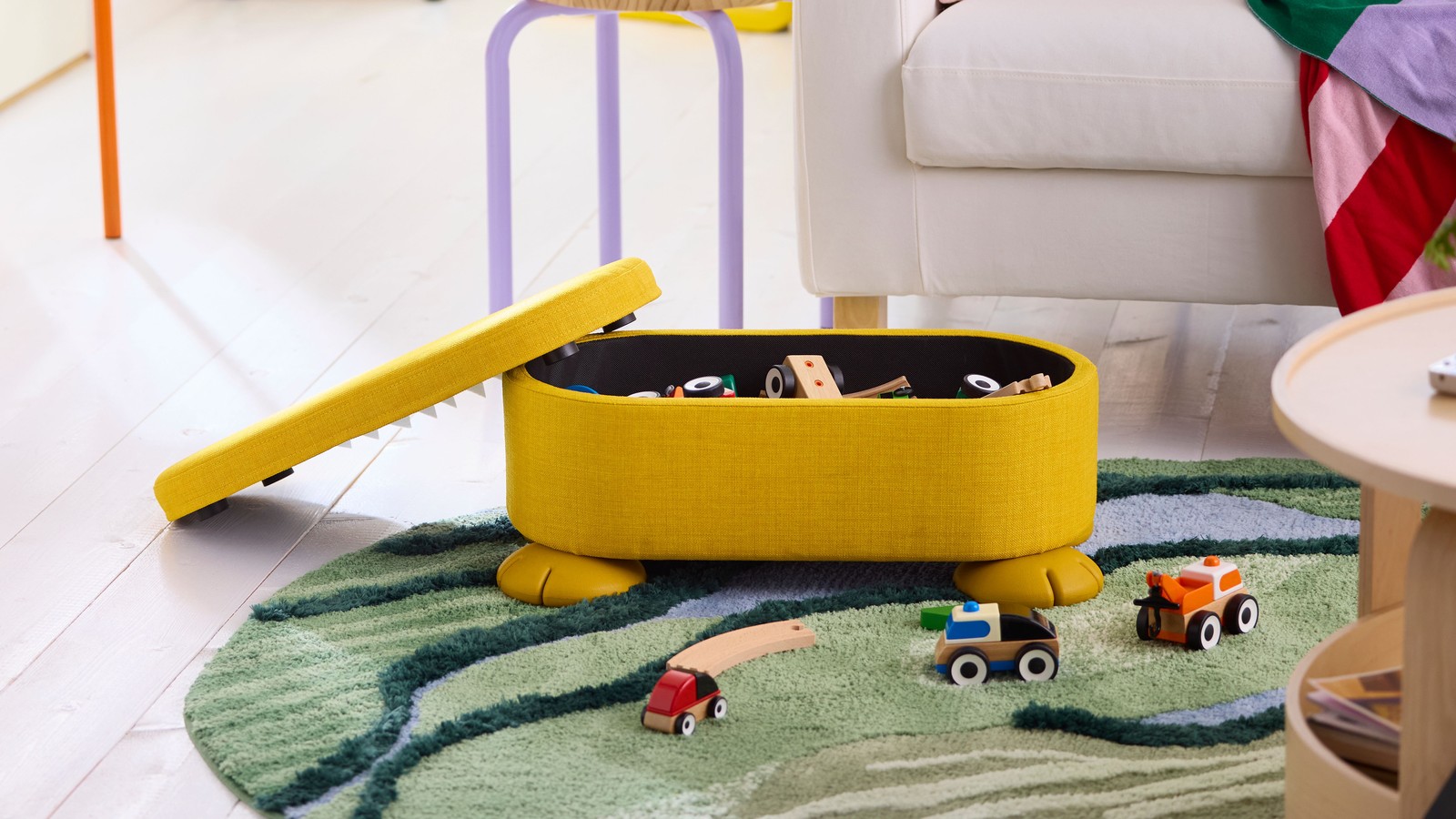 An yellow GREJSIMOJS pouffe with storage in the NA