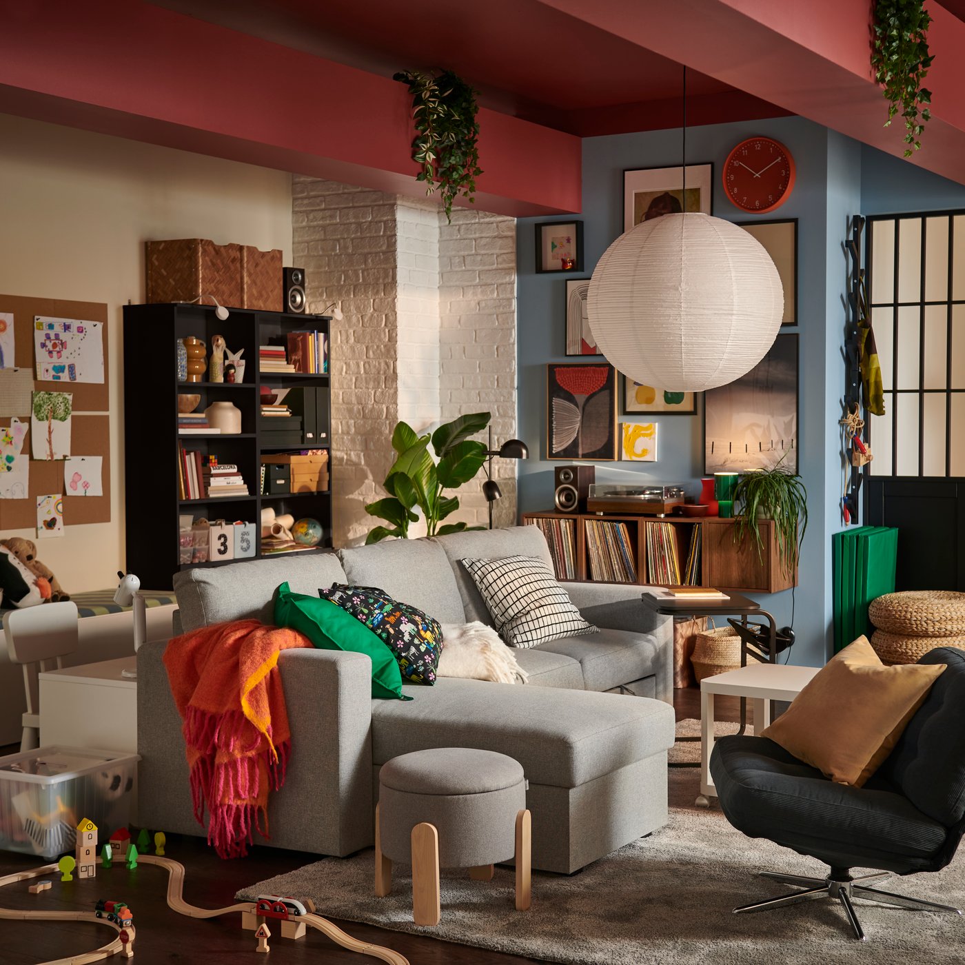 A light living room featuring a beige/grey BÅRSLÖV 3-seat sofa-bed with chaise lounge, surrounded by playful decor.