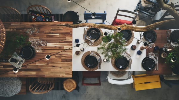 An acacia/black SKOGSTA dining table
