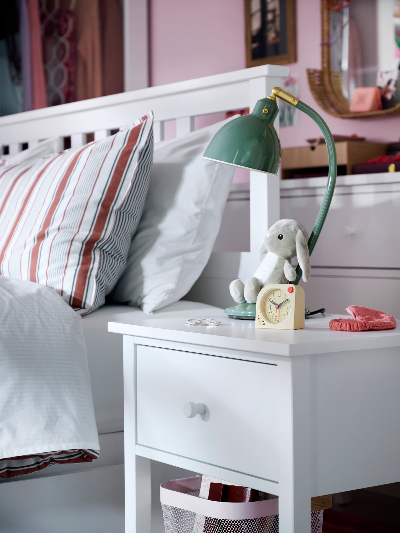 Close-up of GULLABERG bedside table with TJINGA alarm clock, DVÄRGHARE soft toy rabbit and RÖDFLIK desk lamp.