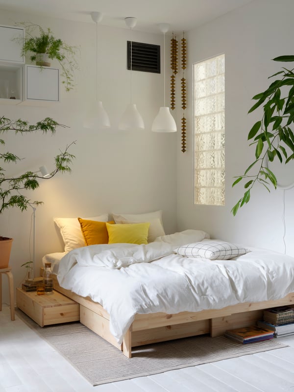 Un lit extensible GLAMBERGET en pin avec rangement dans la chambre à coucher