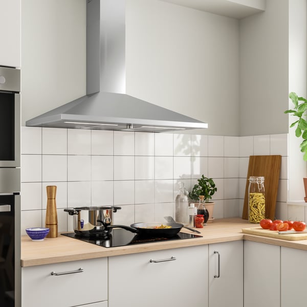 A stainless steel RYTMISK wall mounted extractor hood