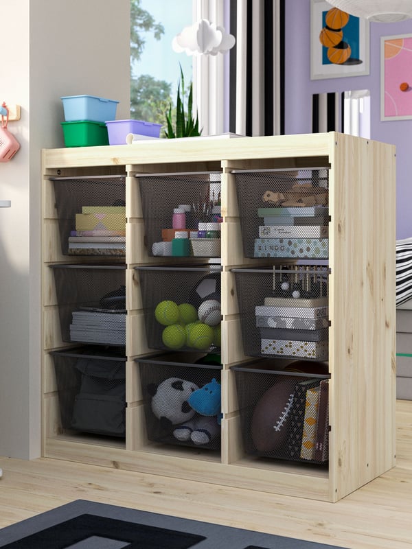 A room divider/light white stained pine dark grey TROFAST storage combination with boxes