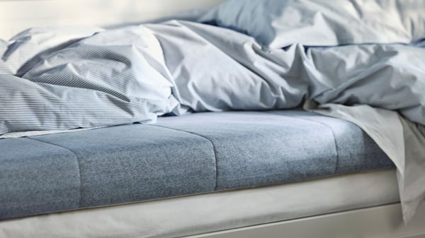 A firm/light blue ÅGOTNES foam mattress