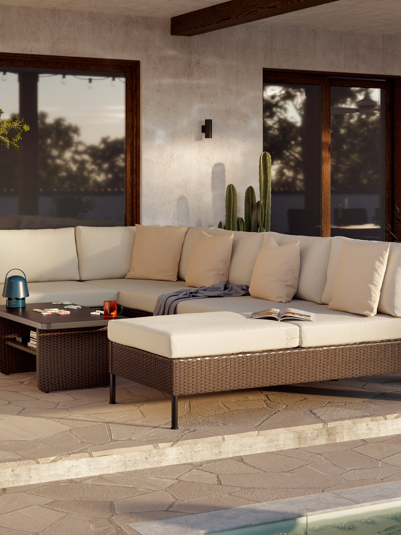 A large outdoor seating area with VITTSKÄR modular sofas and coffee table in dark grey.