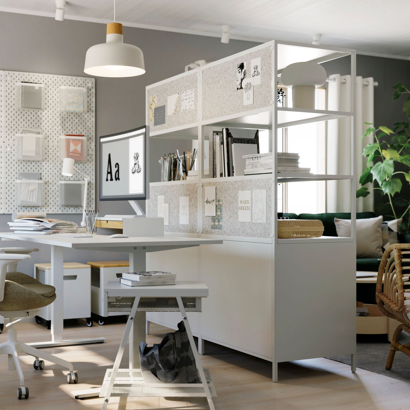 Two white TROTTEN desks with monitors and several TROTTEN cabinets with sliding doors in the back, one with shelves on top.