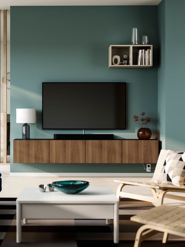 A black-brown Lappviken/brown walnut effect BESTÅ TV bench with doors in the living room