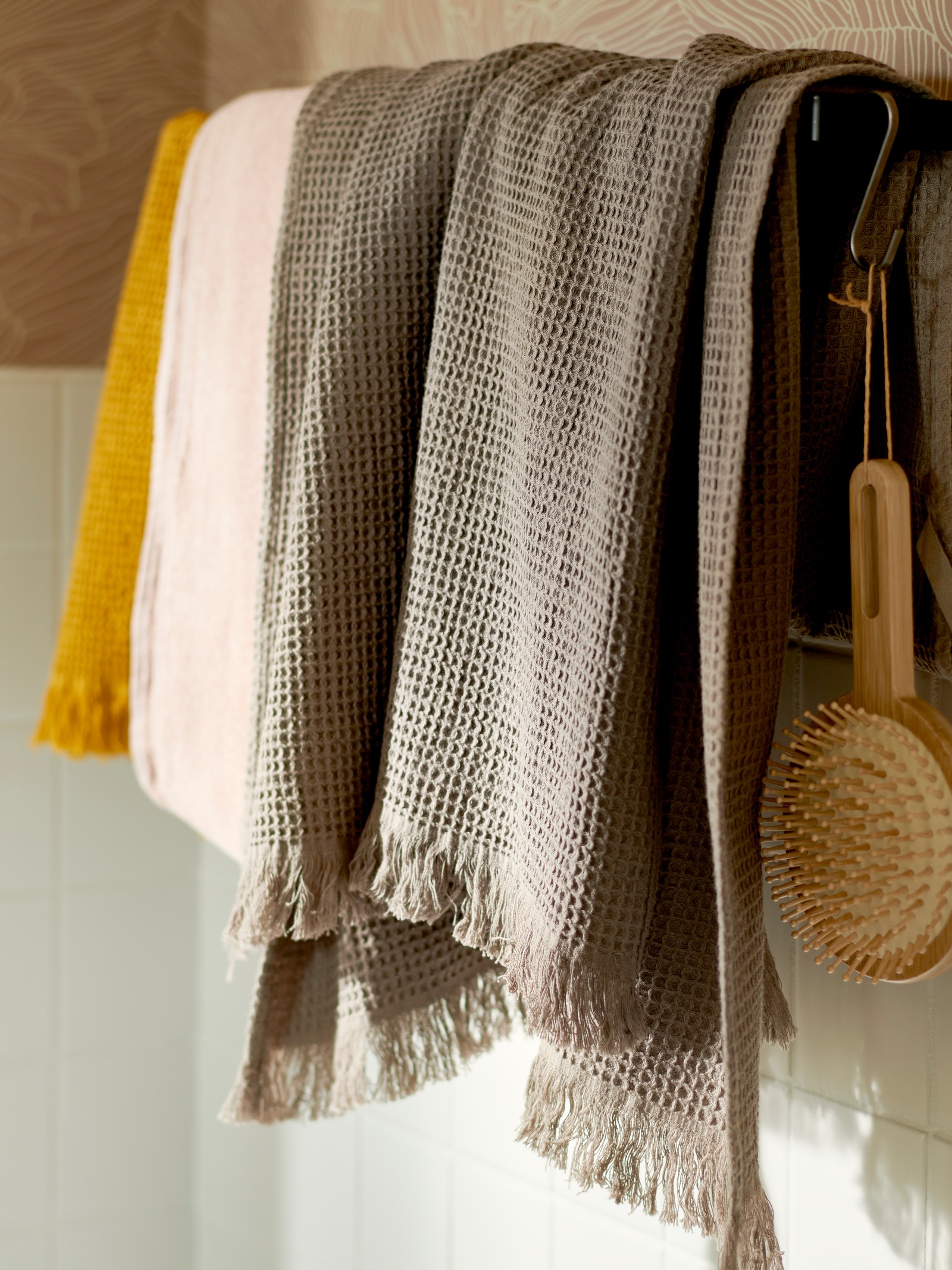 VALLASÅN light brown towel hung on a towel rail