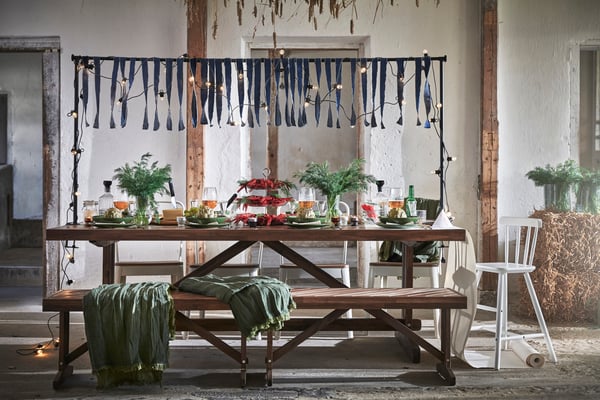 A white adjustable/outdoor indoor  HELGEÖ decorating rod for table in the dining room