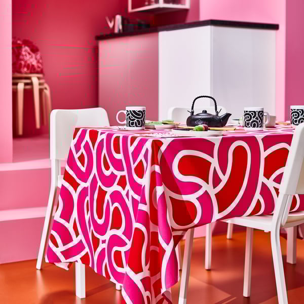 A patterned white/bright red bright pink SÖTRÖNN tablecloth in the dining room