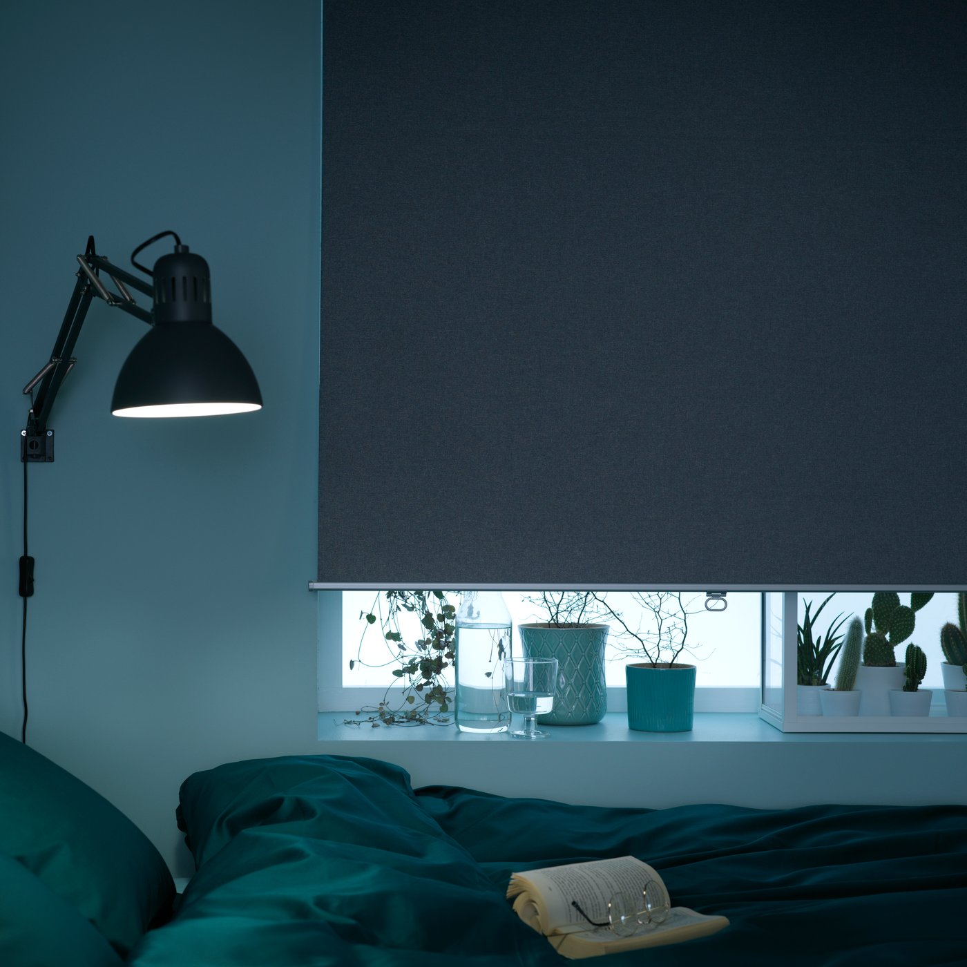 A dark grey TERTIAL work lamp in the bedroom