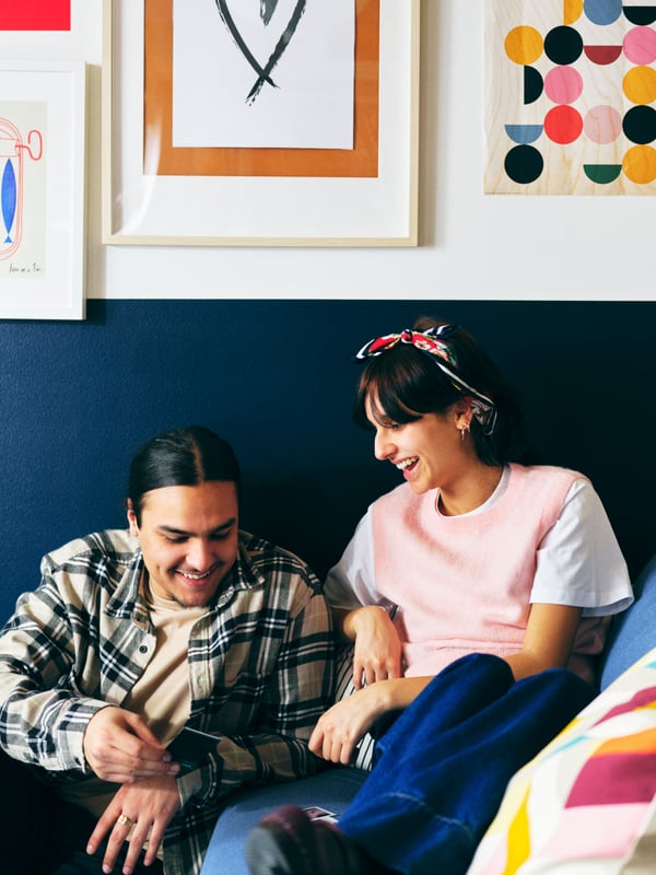 A man and woman designing the lay-out and accompanying furniture for their livingroom