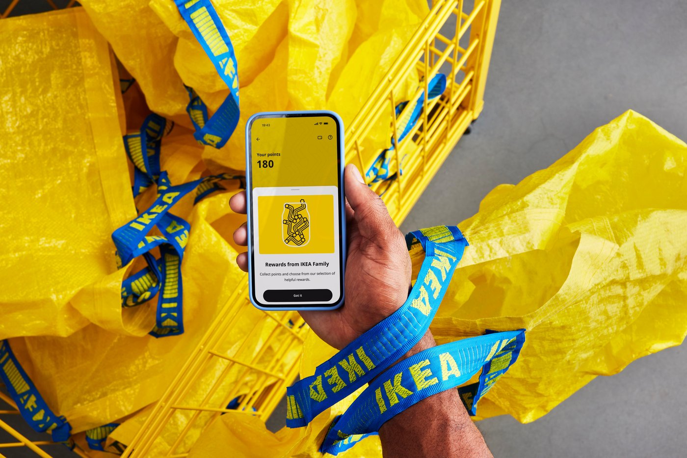 A person holding a phone in an IKEA store.