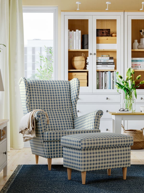 A Sulviken blue/beige STRANDMON wing chair with footstool in the living room