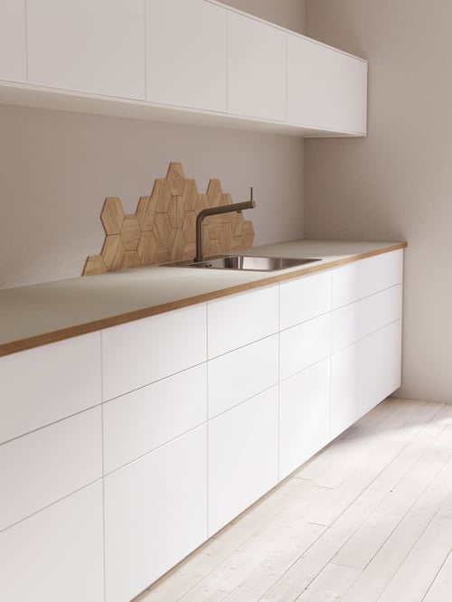 Modern kitchen with a white base cabinet with three self-closing drawers of different sizes to accommodate all sorts of items.