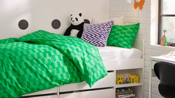 A panda DJUNGELSKOG soft toy in the childrens room