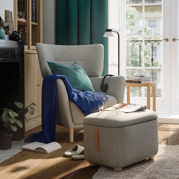 A Tibbleby beige/grey OSKARSHAMN wing chair in the living room