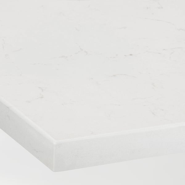 Close-up of a white marble-look countertop with subtle gray veining and a smooth, polished finish.