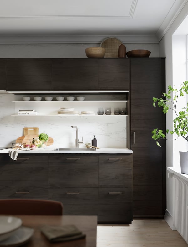 A white BOTKYRKA wall shelf in the kitchen