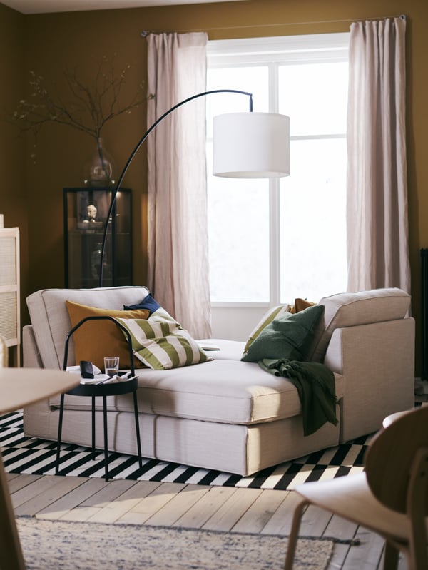 A handmade/striped black/off-white STOCKHOLM rug, flatwoven in the living room