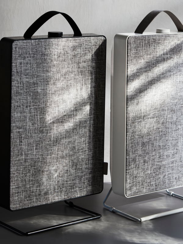 A black FÖRNUFTIG air purifier in the living room