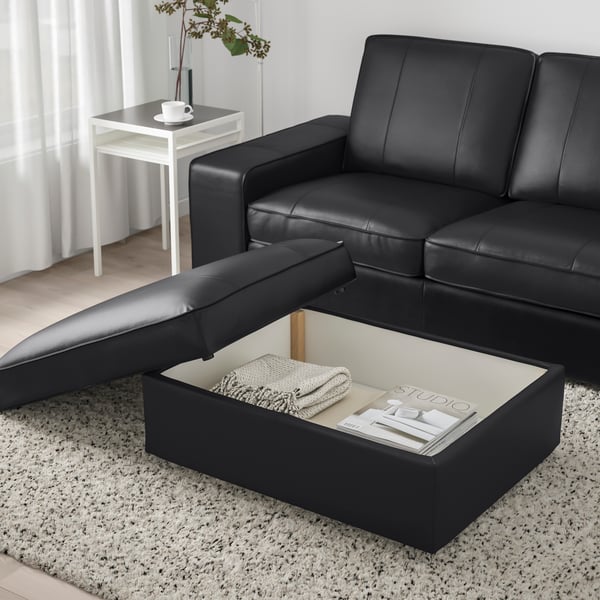 A Grann/Bomstad black KIVIK footstool in the living room