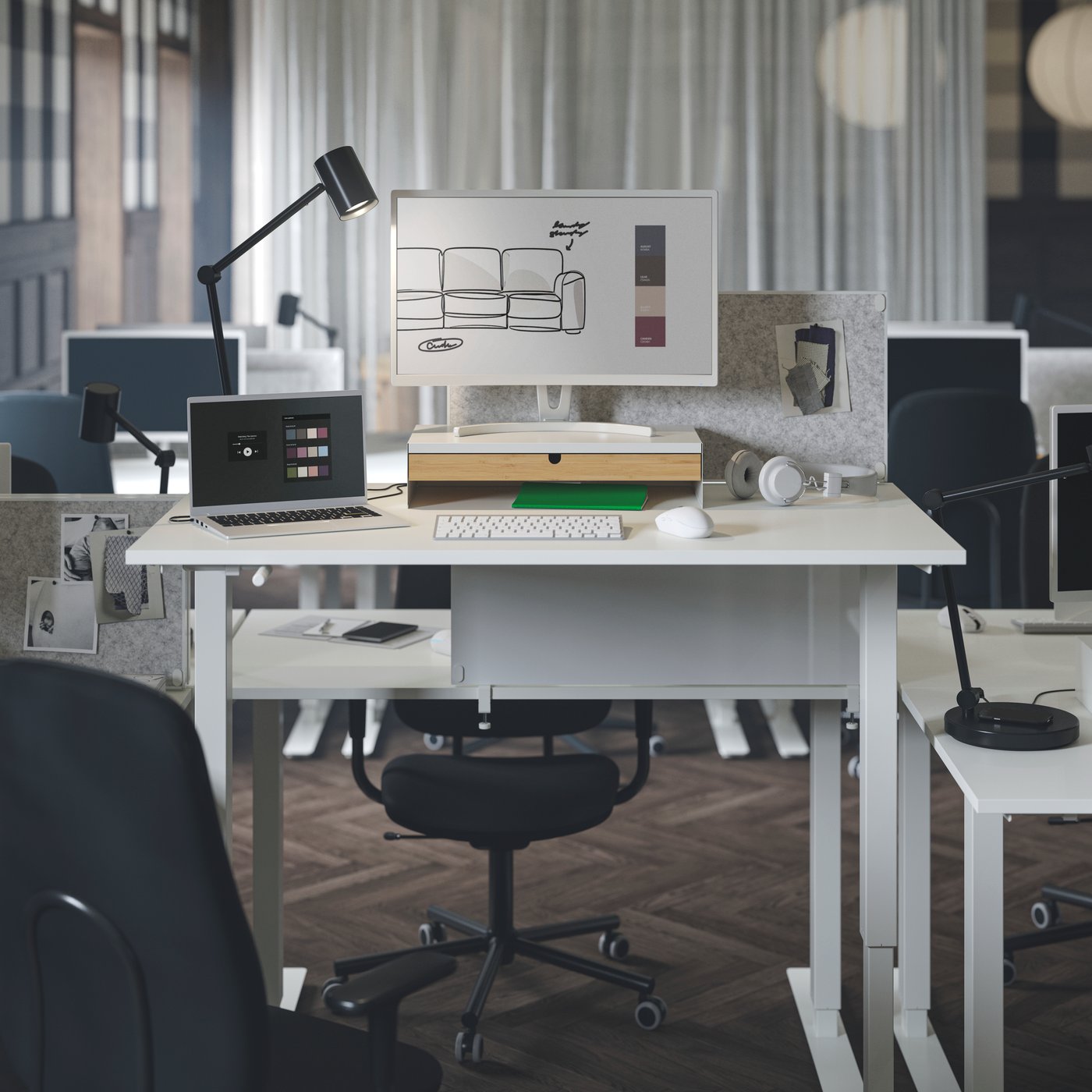 Two white TROTTEN sit/stand desks with noticeboards attached on both sides, surrounded by SMÖRKULL office chairs.