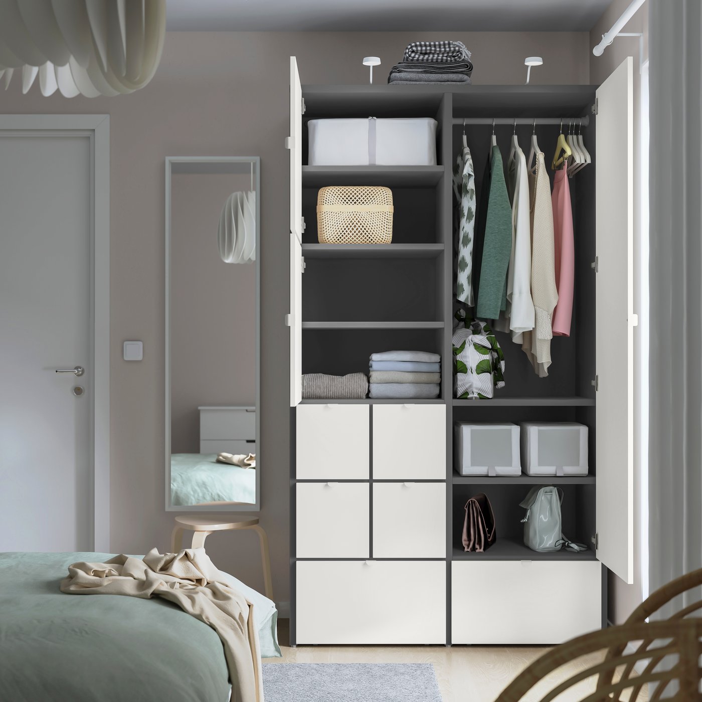A grey/white VISTHUS wardrobe in the bedroom