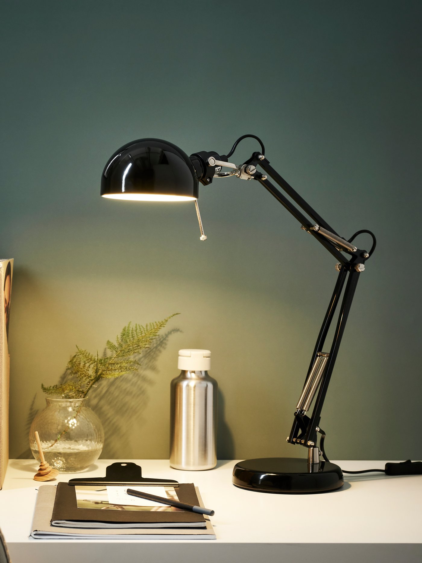 A black FORSÅ work lamp
